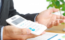 電卓を提示しているスタッフ